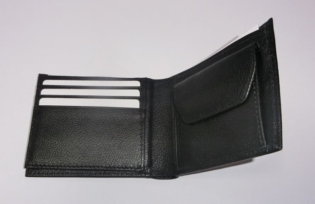 Open black pebbled leather bifold wallet with card slots and coin pocket