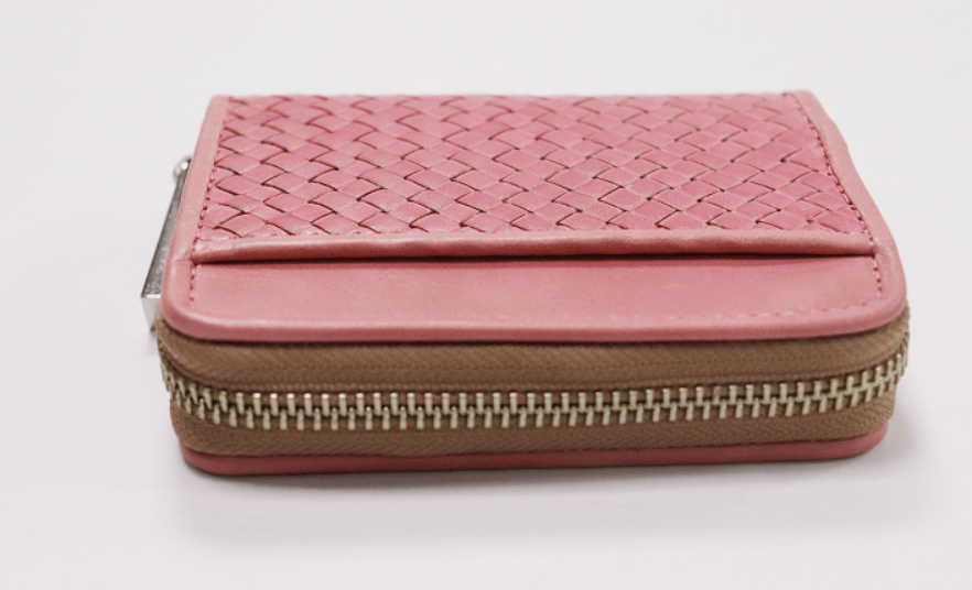 Dusty rose pink zip-around coin purse with woven top panel and smooth leather sides