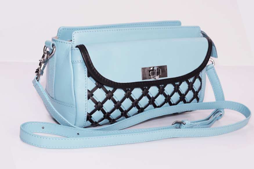 Sky blue flap crossbody with black lattice accent and turn-lock closure
