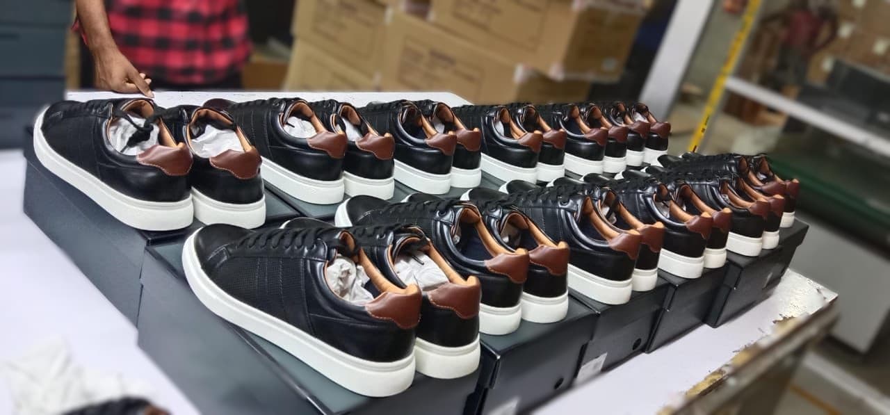 Finished black sneakers with white soles arranged for packing