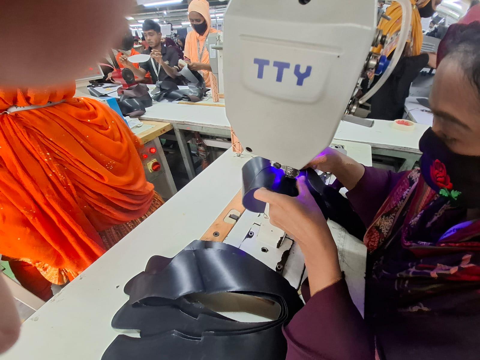 Industrial sewing of footwear components on the production line